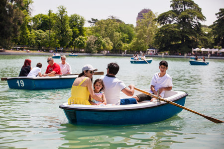 MADRID, SPAIN - MAY, 2018: Tourists and locals enjoying a beautiful spring day sailing at the Retiro...