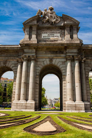 The famous Puerta de Alcala on a beautiful sunny day in Madrid City. Inscription on the pediment: King Carlos III year 1778の写真素材