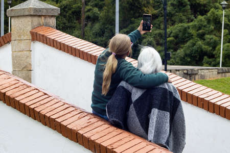 Senior mother and adult daughter traveling. The famous historic Bridge of Boyaca in Colombia. The Colombian independence Battle of Boyaca took place here on August 7, 1819.の写真素材