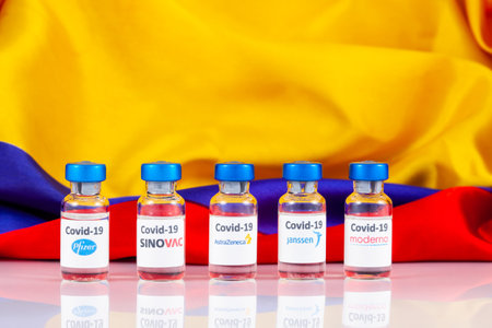 BOGOTA, COLOMBIA - FEBRUARY 2021. Vaccine vials and Colombian flag. Vaccination concept.のeditorial素材