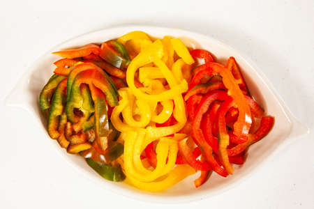 Fish marinade preparation steps: Red, green and yellow pepper cut in julienne stripsの写真素材