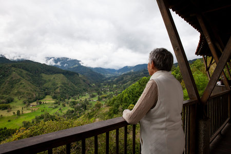Senior woman at the beautiful view point over the Cocora Valley in Salento, located on the region of Quindio in Colombiaの写真素材