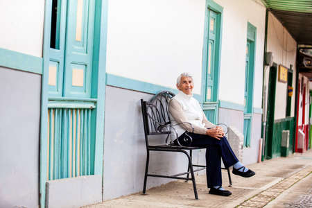Senior woman traveling at the beautiful small town of  Salento, located on the region of Quindio in Colombiaの写真素材
