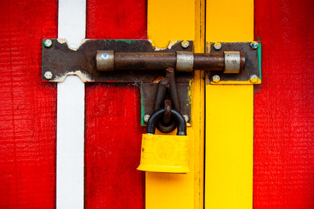 Colorful painted door with a closed lock at the small town of Salento in Colombia