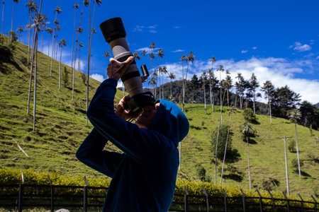 Tourist taking pictures at the beautiful Valle de Cocora located in Salento at the Quindio region in Colombiaの写真素材