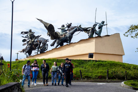 MANIZALES, COLOMBIA - MAY, 2022: Tourists at the Monument to the Colonizers created by the artist Luis Guillermo Vallejo with the sand bronze casting techniqueのeditorial素材