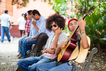CARTAGENA DE INDIAS, COLOMBIA - AUGUST, 2011: Two young male musicians with their guitars at the San Diego Square in Cartagena de Indias city centerのeditorial素材