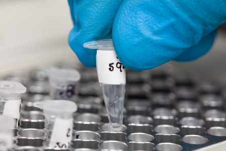 Closeup of a scientist hand while working at the laboratory with a thermal cycler. Polymerase chain...