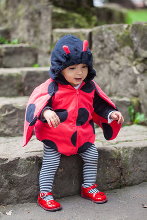 Little baby girl wearing a ladybug costume. Halloween concept.の写真素材