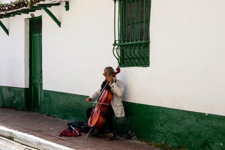 Bogota, Colombia - July 2nd 2023. Senior male musician performing on the streets of La Candelaria at the city center of Bogotaのeditorial素材