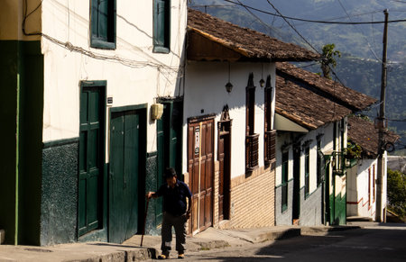 SALAMINA, COLOMBIA - JANUARY 14, 2024: Senior local man walking at the beautiful streets at the historical downtown of the heritage town of Salamina located at the Caldas department in Colombia.のeditorial素材