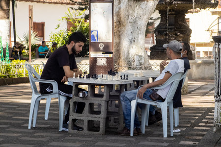 SALAMINA, COLOMBIA - JANUARY 14, 2024: People playing chess at the central square of the heritage town of Salamina located at the Caldas department in Colombia.のeditorial素材