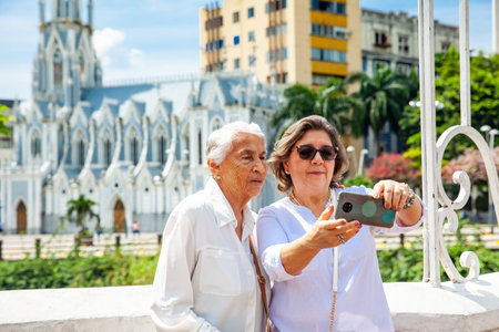 Senior mother and daughter traveling together having fun. Senior adults in Cali Colombia. Senior lifestyle. Senior travel.の写真素材