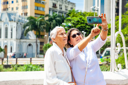 Senior mother and daughter traveling together having fun. Senior adults in Cali Colombia. Senior lifestyle. Senior travel.の写真素材