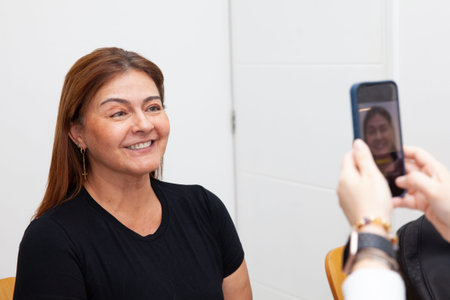 Dermatologist taking pictures to a middle age female patient prior to application of Botulinum toxin...