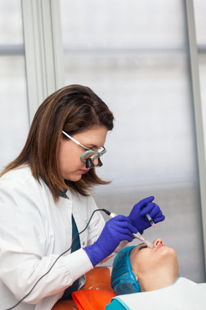 Application of an anti-aging facial rejuvenation cocktail using micro needles. Dermatology concept....