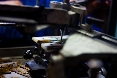Close up of the process of Handcrafted engraving of texts on medals or jewelry.