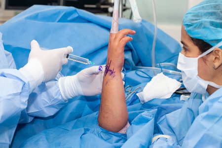 Female doctor performing a surgery. Orthopedic surgeon. Surgery and insurance concept.の写真素材