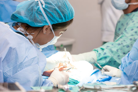 Female doctor performing a surgery. Orthopedic surgeon. Surgery and insurance concept. Hand surgery. Traumatology and orthopedics concept.の写真素材