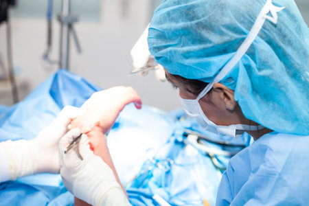Female doctor performing a surgery. Orthopedic surgeon. Surgery and insurance concept.の写真素材