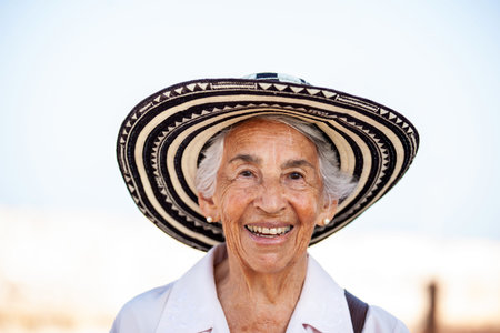 Senior woman tourist wearing a vueltiao hat in Cartagena. Senior travel concept. Senior lifestyle.