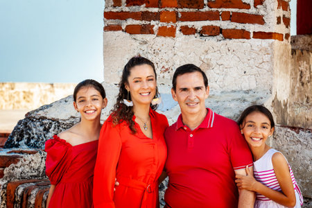 Young family of four traveling together. Family love concept. Travel concept. Cartagena de Indias.