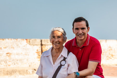 Adult son and his senior mother in Cartagena de Indias. Real family. Family love. Family travel concept.の写真素材