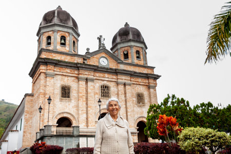 Senior woman at the beautiful colonial town of Concepcion located in the department of Antioquia in Colombia. Church of Our Lady of the Immaculate Conception.の写真素材