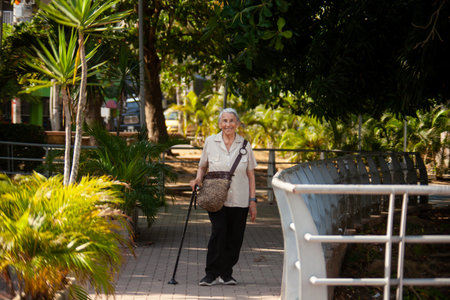 Senior woman at the Ronda del Sinu walking path along the river bank in the city of Montería, Colombia.の写真素材