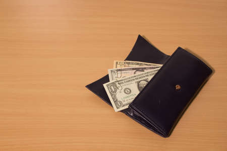 black wallet with dollarsの写真素材