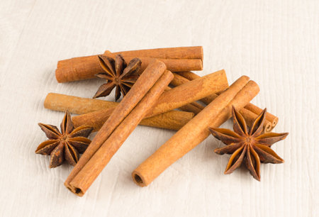 Cinnamon and anise on the wooden background