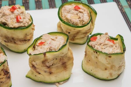 Grilled zucchini rolls with curd cheese and tuna on plate. Top view with copy spaceの写真素材