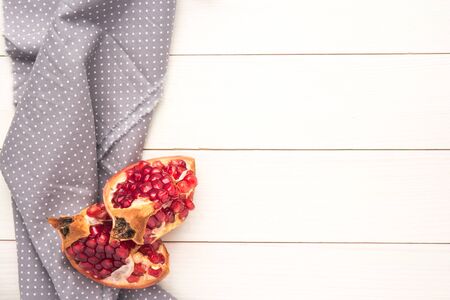 Red ripe peeled pomegranate on rustic wood board background. Top view, copy spaceの写真素材