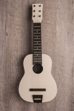 Guitar on rustic wooden background texture. Top view with copy spaceの写真素材