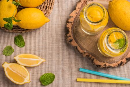 Glass of homemade lemonade with mint and lemon wedges. Top view with copy space.の写真素材