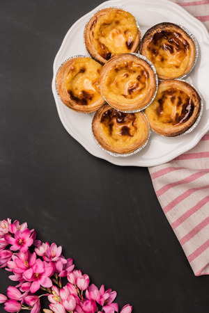 Pasteis de nata, typical Portuguese egg tart pastries on a set table. Top view with copy spaceの写真素材