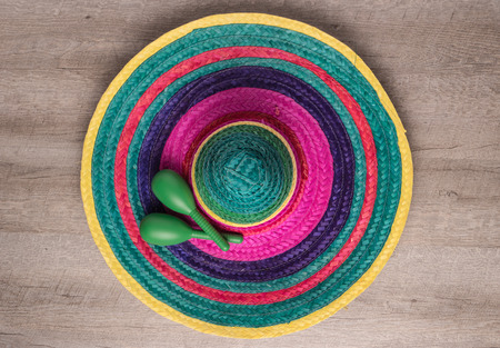 Mexican background. Sombrero and maracas on rustic wooden background. Top view with copy spaceの写真素材