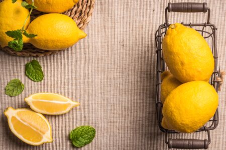 Slices, half fresh juicy lemon with mint leaves. Top view with copy space.の写真素材