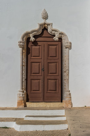 Historically church door of the Alvor Mother Church dedicated to divine Savior, Alvor, Portugal.の写真素材