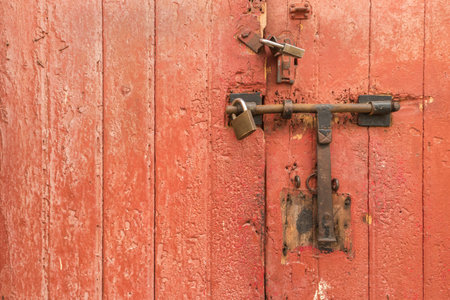 Old rusty padlock on wooden door. Home securityの写真素材