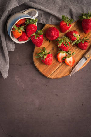 Red berry strawberry in ceramic mugs on old concrete background. Background from freshly harvested strawberriesの写真素材