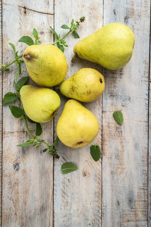 Fresh organic pears on old wood. Fruit background. Pear autumn harvest.の写真素材