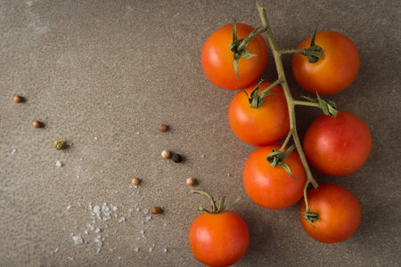Top view of a bunch of natural cherry tomatoes on cement background with copy space.の写真素材