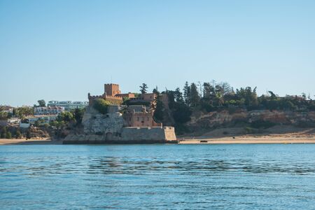 The magnificent Fort of Sao Joao do Arade in Ferragudo, sometimes referred to as the Castle of Arade, viewed from the Port of Portimao.のeditorial素材