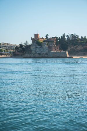 The magnificent Fort of Sao Joao do Arade in Ferragudo, sometimes referred to as the Castle of Arade, viewed from the Port of Portimao.のeditorial素材