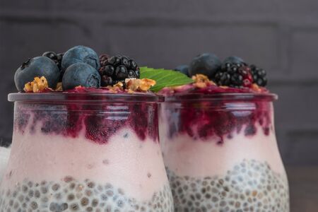 Chia pudding parfait with blackberries and blueberry smoothie and granola.の写真素材