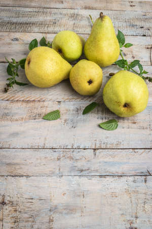 Fresh organic pears on old wood. Fruit background. Pear autumn harvest.の写真素材
