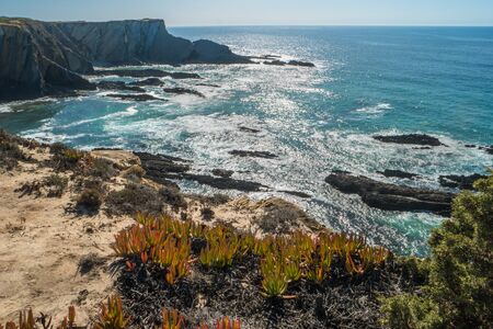 Beach with rocks in Praia do Cavaleiro in Alentejo, Portugalの写真素材