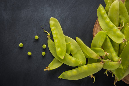 Fresh snow peas on slate background