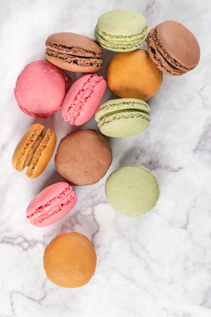Colorful macaroons on marble background. Sweet macarons. Top view with copy space for your text.の写真素材